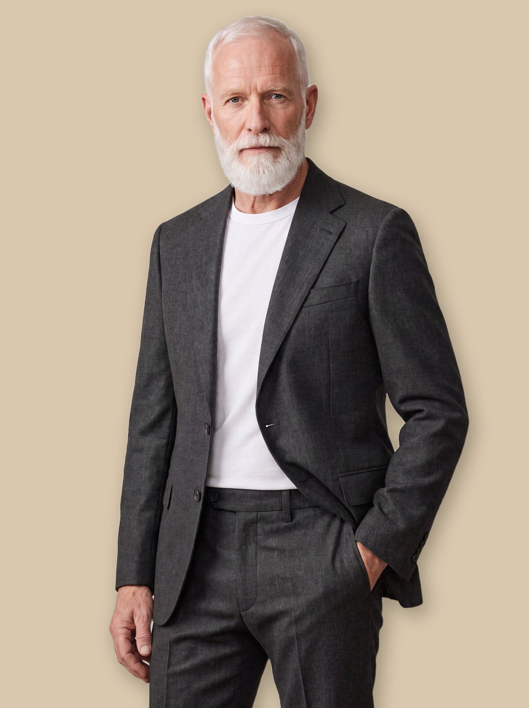 Ellsworth blazer suit in Charcoal, worn by a model on a warm sand studio background - Gentlemens Manor
