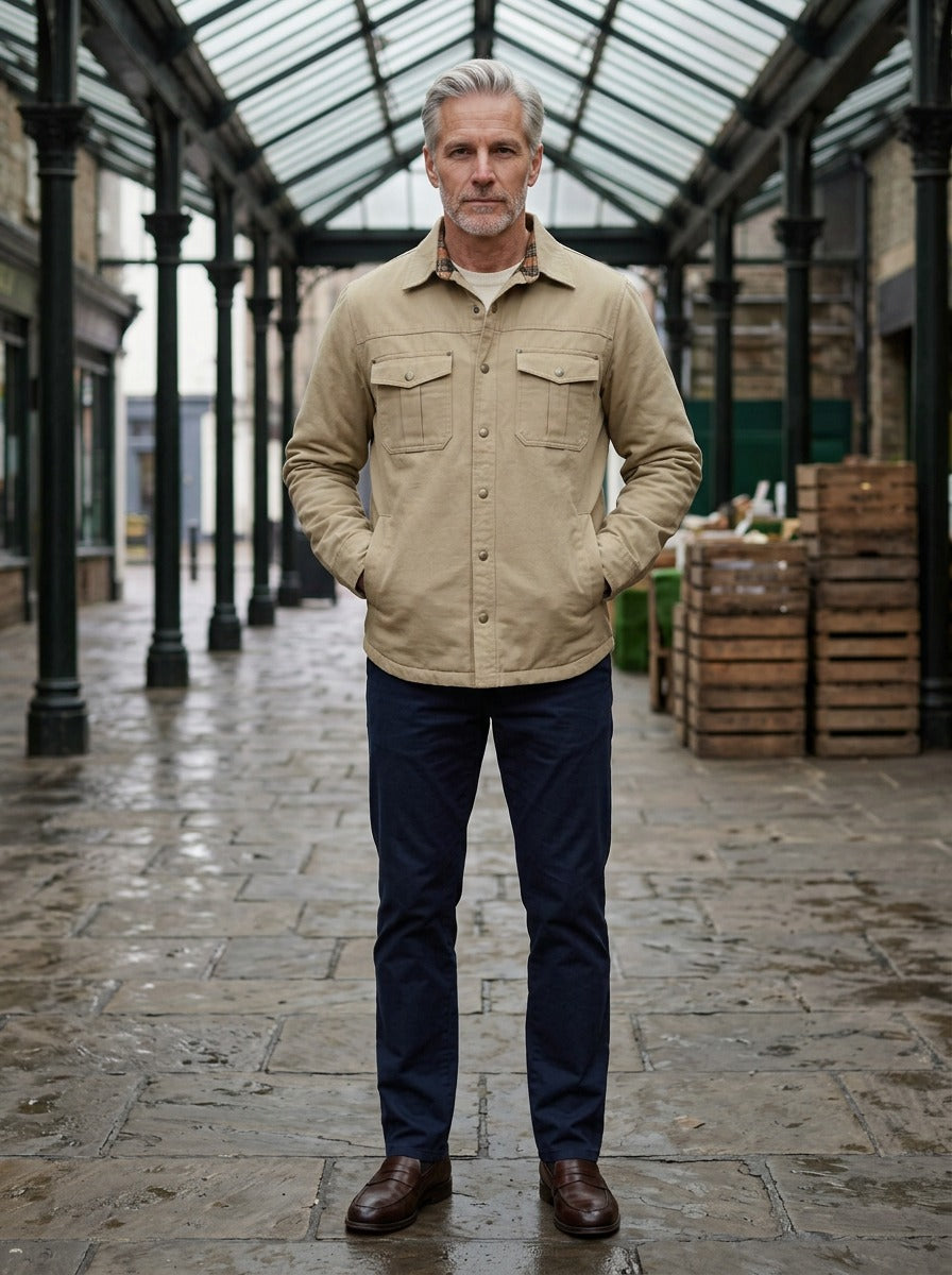 Elmwood flannel lined shirt jacket in Sand, lifestyle in a covered market hall, Gentlemens Manor