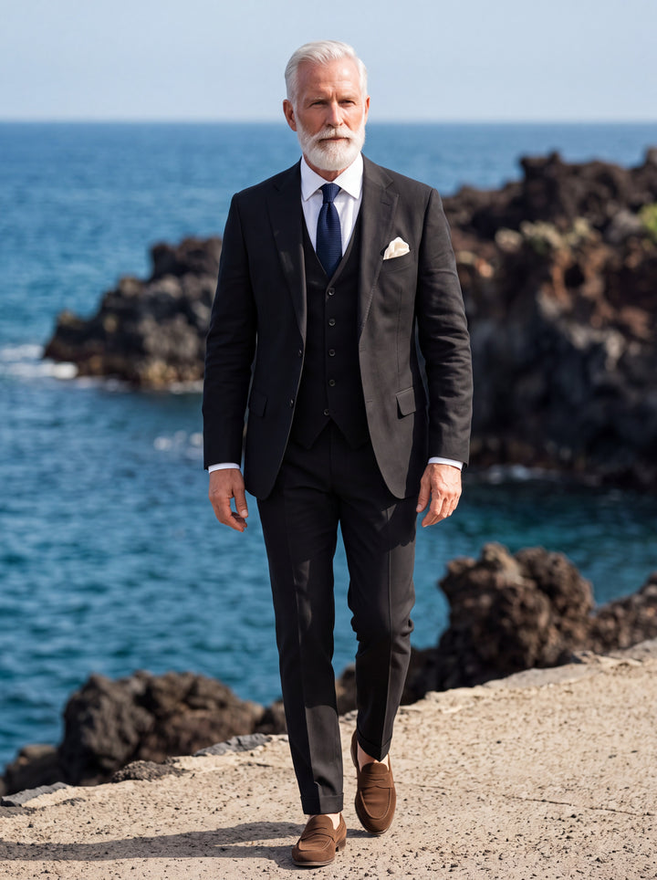 Elwood Men three-piece suit in black, worn by a model in a Mediterranean setting - Gentlemens Manor lifestyle