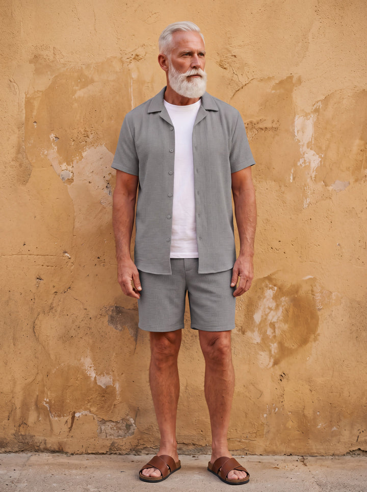 Emmett Men two-piece summer set in grey, worn by a model in a Mediterranean setting - Gentlemens Manor lifestyle