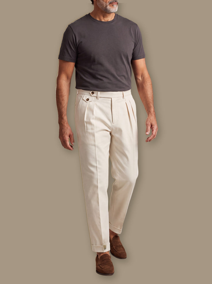 Enoch trousers in Beige, worn by a model on a warm taupe studio background - Gentlemens Manor