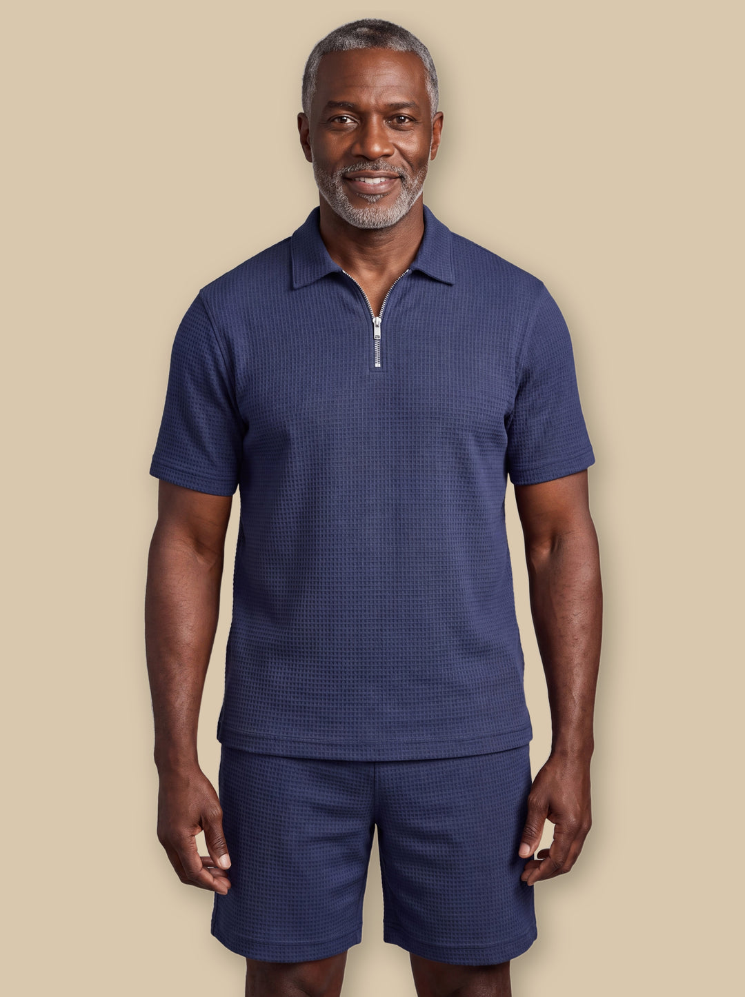 Ezra two piece set in Navy, worn by a model on a warm sand studio background - Gentlemens Manor
