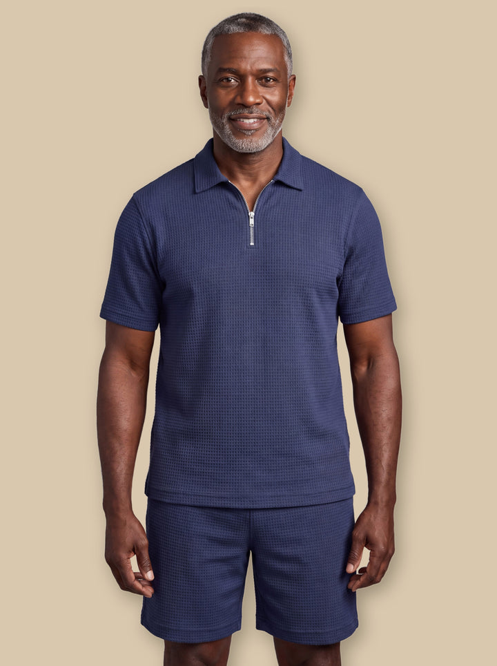 Ezra two piece set in Navy, worn by a model on a warm sand studio background - Gentlemens Manor