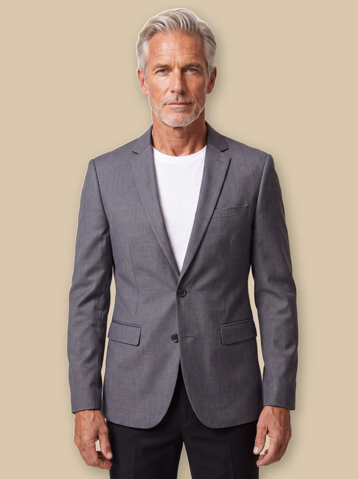 Felix blazer suit in Grey, worn by a model on a warm sand studio background - Gentlemens Manor