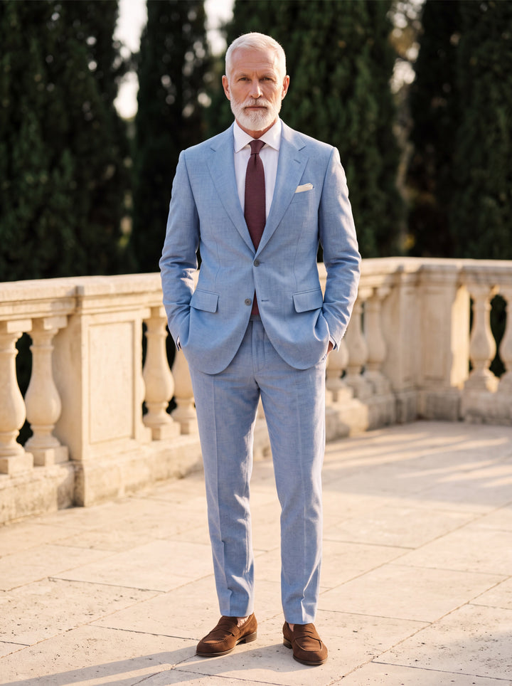 Fitzgerald Men two-piece suit in blue, worn by a model in a Mediterranean setting - Gentlemens Manor lifestyle
