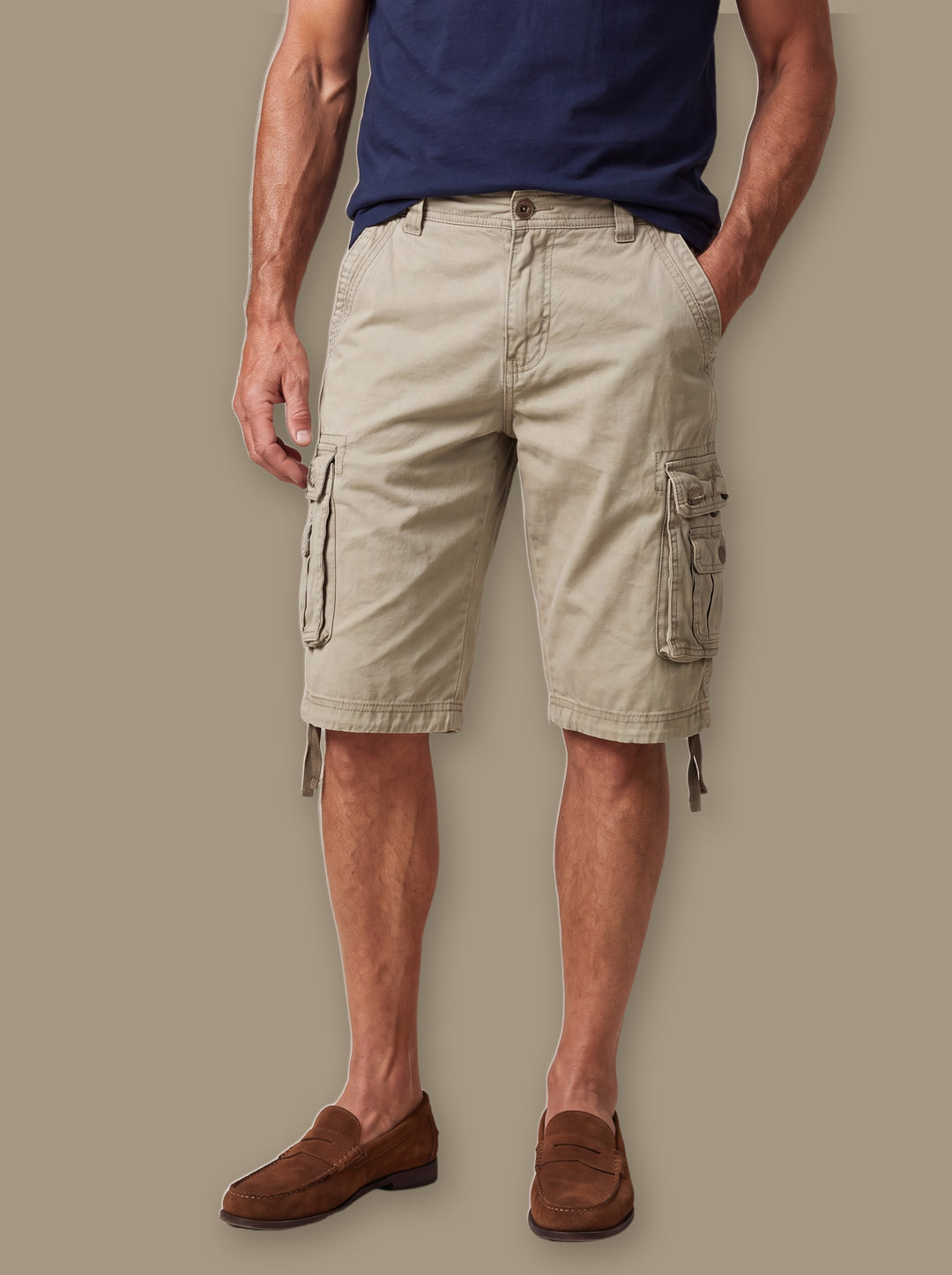 Fletcher summer shorts in Sand, worn by a model on a warm taupe studio background - Gentlemens Manor