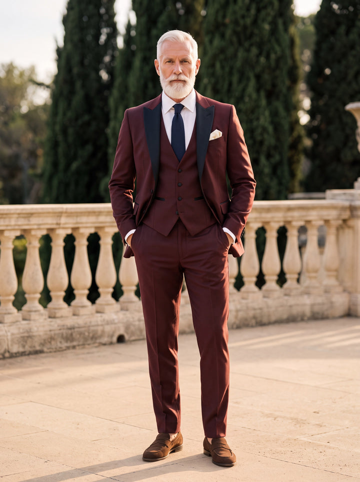 Floyd Men three-piece suit in burgundy, worn by a model in a Mediterranean setting - Gentlemens Manor lifestyle