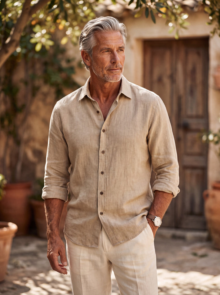 Forsyth Men linen shirt in Sand, worn by a model on a Mediterranean terrace - Gentlemens Manor lifestyle