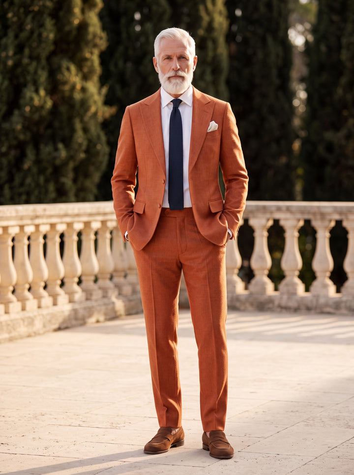 Franklin Men two-piece suit in orange, worn by a model in a Mediterranean setting - Gentlemens Manor lifestyle