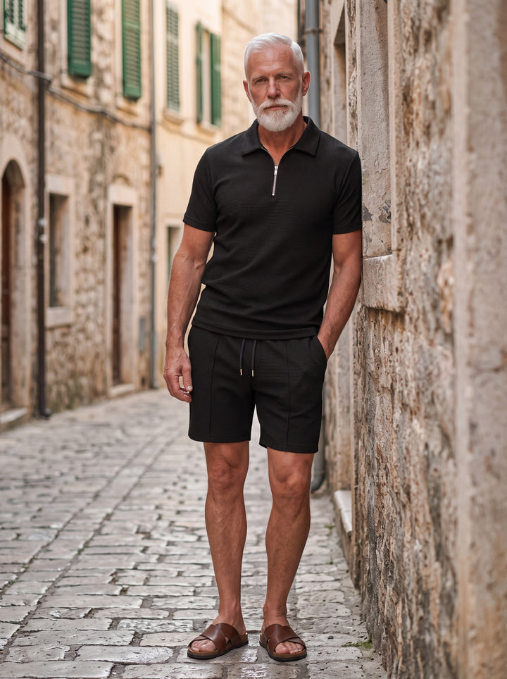 Freeman Men two-piece summer set in black, worn by a model in a Mediterranean setting - Gentlemens Manor lifestyle