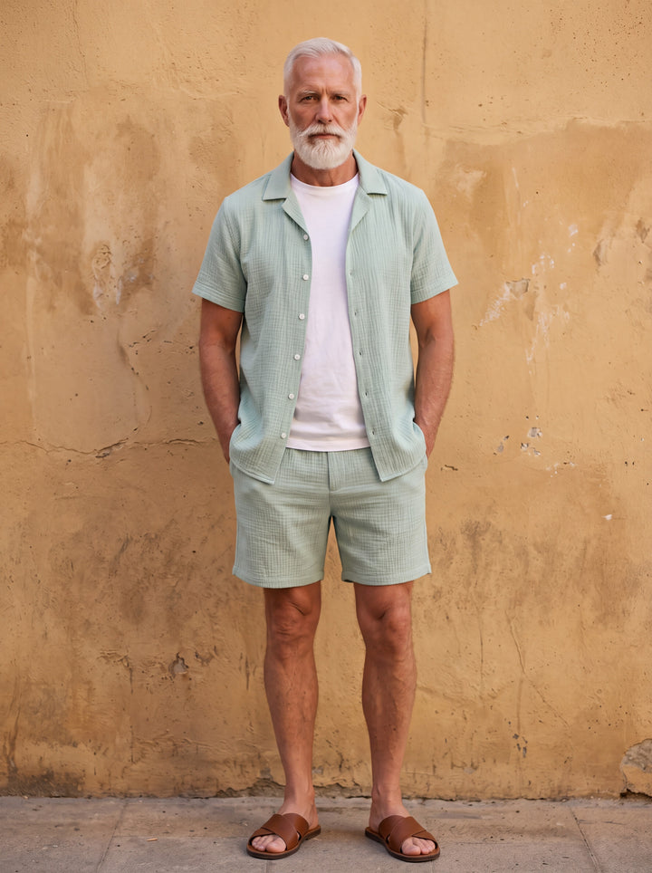 Gabriel Men two-piece summer set in green, worn by a model in a Mediterranean setting - Gentlemens Manor lifestyle