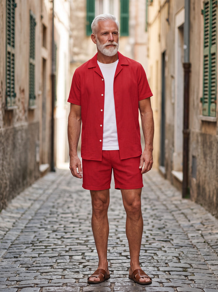 Gabriel Men two-piece summer set in red, worn by a model in a Mediterranean setting - Gentlemens Manor lifestyle