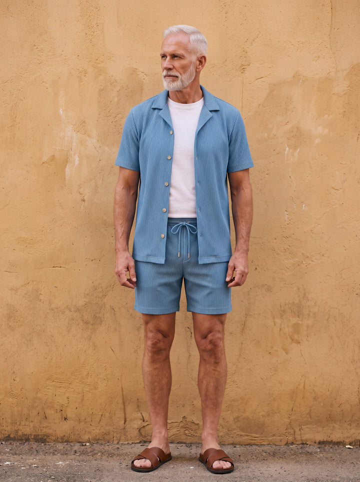Garfield Men two-piece summer set in blue, worn by a model in a Mediterranean setting - Gentlemens Manor lifestyle