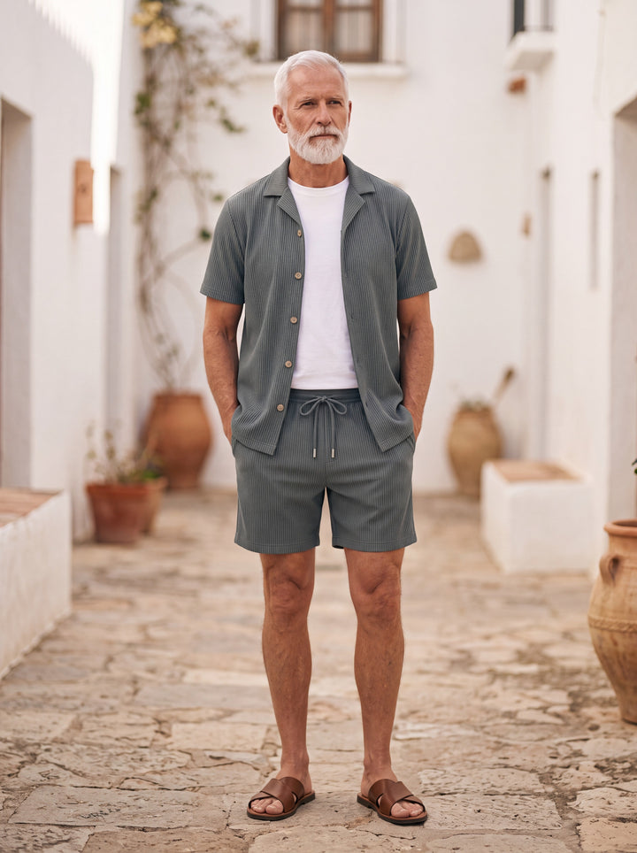 Garfield Men two-piece summer set in charcoal, worn by a model in a Mediterranean setting - Gentlemens Manor lifestyle