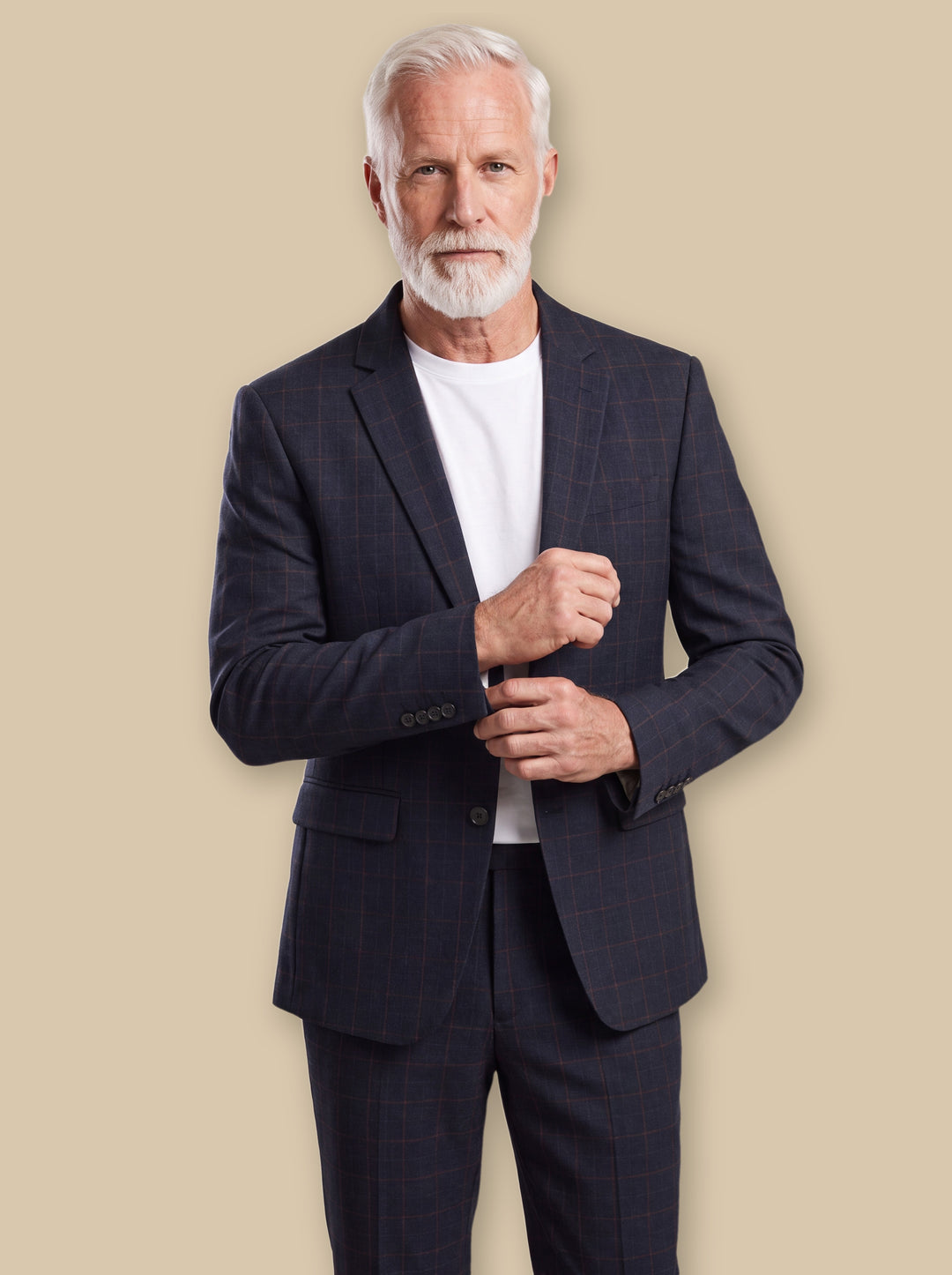 George blazer suit in Black, worn by a model on a warm sand studio background - Gentlemens Manor