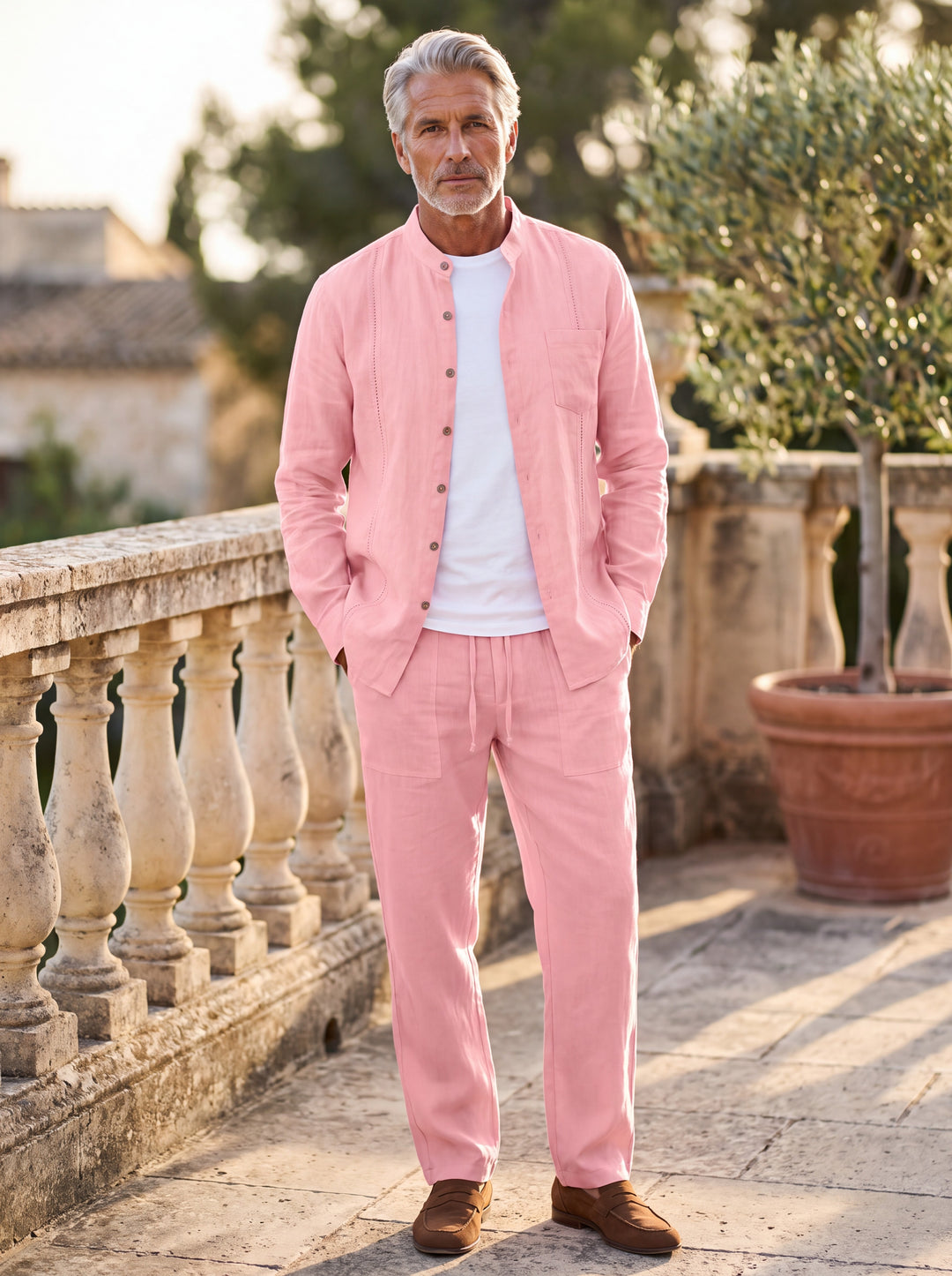 Glenn Men two piece set in pink, worn by a model on a Mediterranean terrace - Gentlemens Manor lifestyle