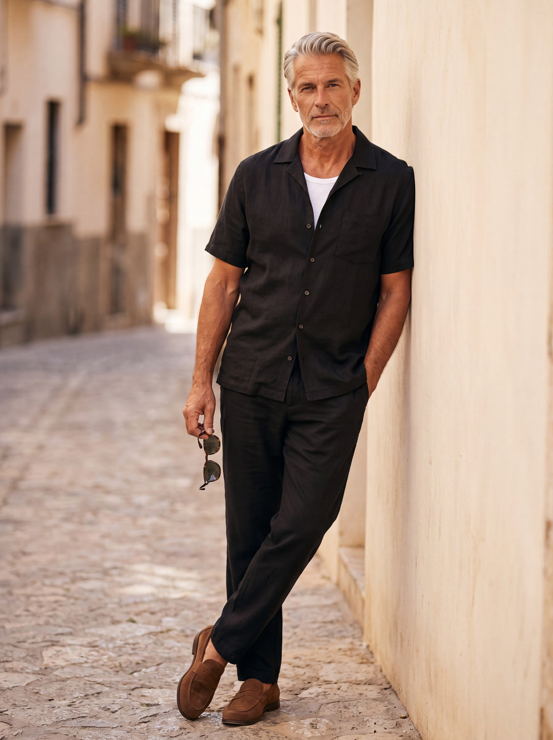 Grady Men two piece set in black, worn by a model on a Mediterranean terrace - Gentlemens Manor lifestyle