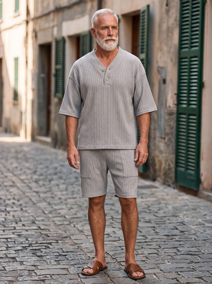 Grant Men two-piece summer set in light grey, worn by a model in a Mediterranean setting - Gentlemens Manor lifestyle