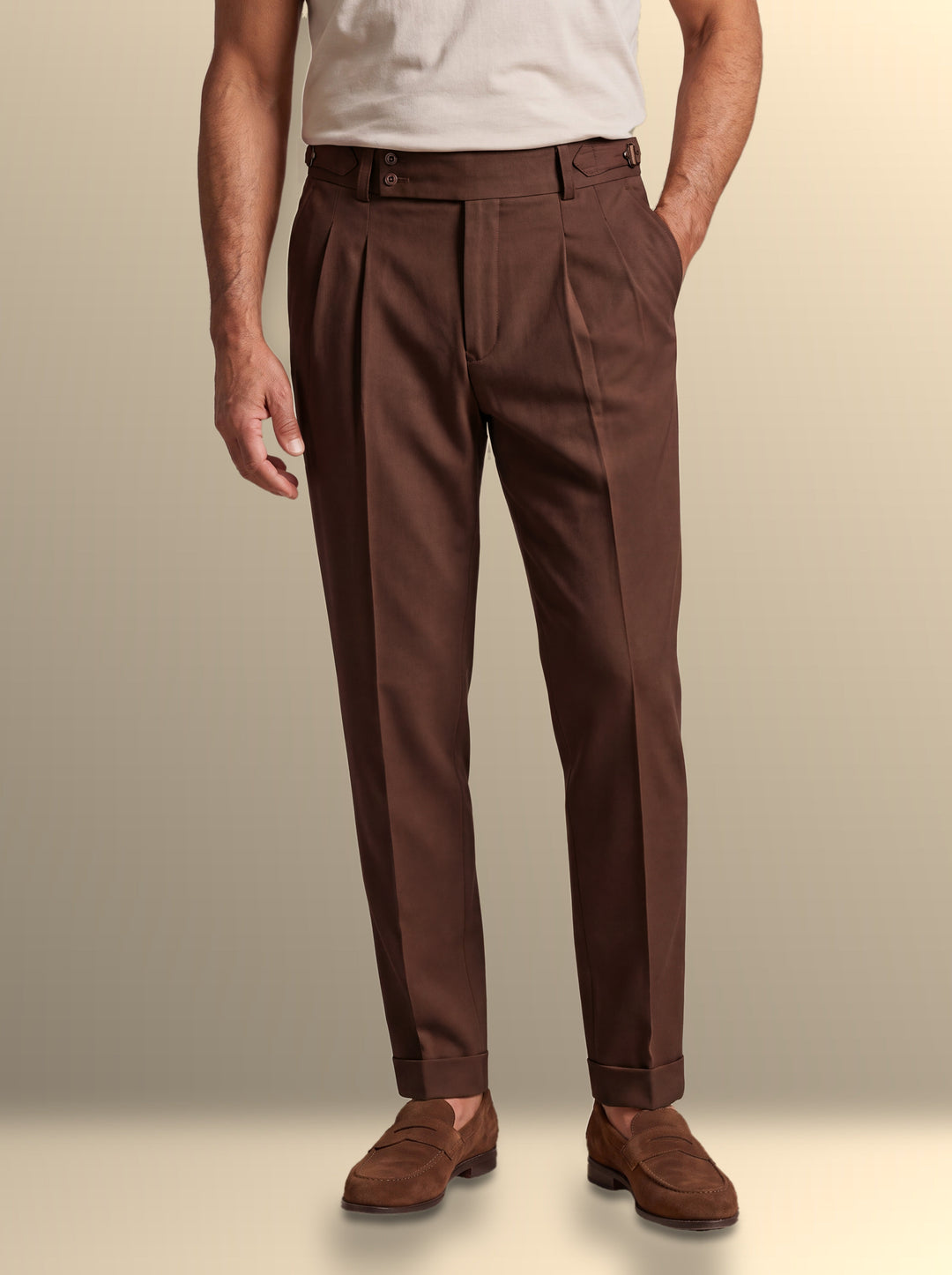Grayson trousers in Dark Brown, worn by a model on a warm sand studio background - Gentlemens Manor