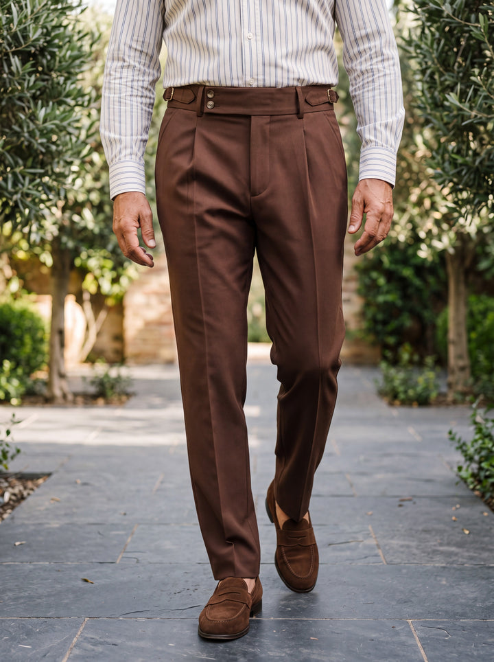 Grayson trousers in Dark Brown, worn by a model in a Mediterranean setting - Gentlemens Manor lifestyle