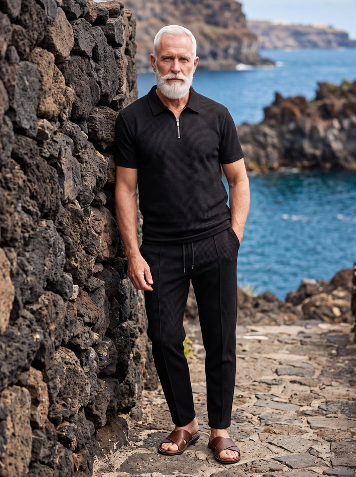 Gregory Men two-piece summer set in black, worn by a model in a Mediterranean setting - Gentlemens Manor lifestyle