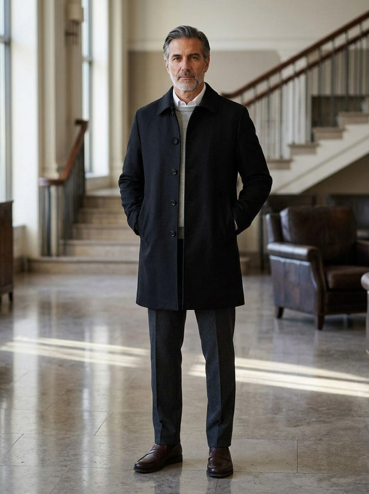 Greville car coat in Black, lifestyle in a hotel lobby, Gentlemens Manor