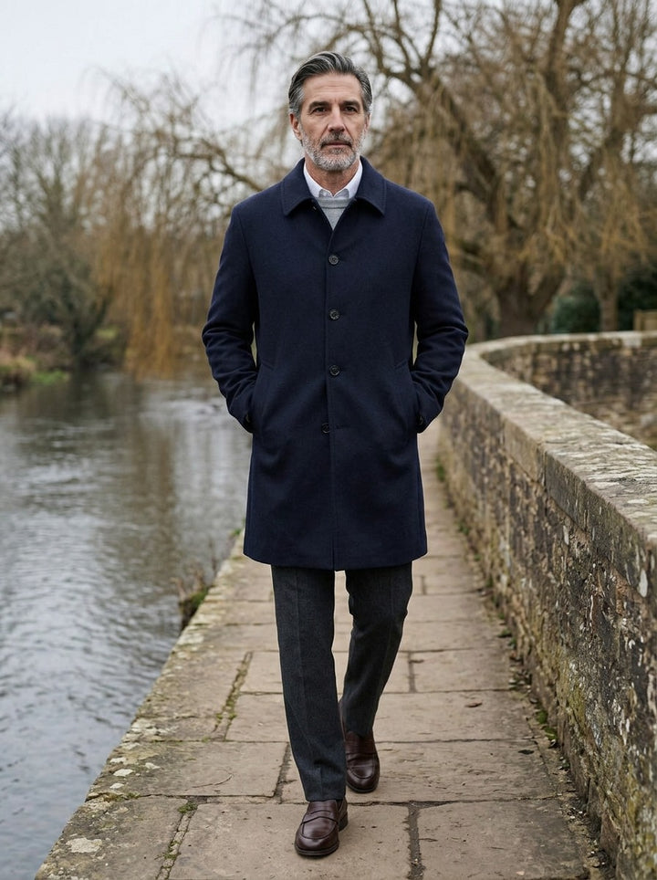 Greville car coat in Navy, lifestyle on a stone footbridge, Gentlemens Manor