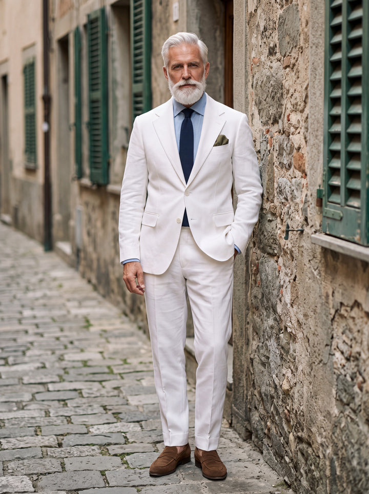 Guy Men two-piece suit in white, worn by a model in a Mediterranean setting - Gentlemens Manor lifestyle