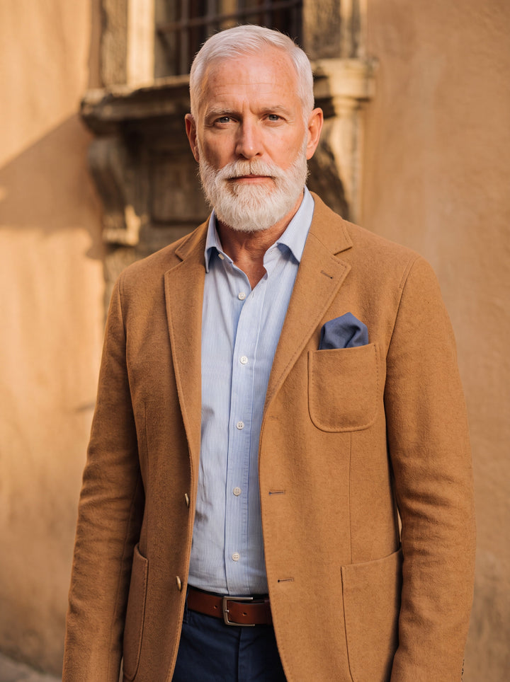 Hadley blazer in Sand, worn by a model in a Mediterranean setting - Gentlemens Manor lifestyle