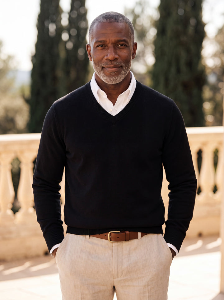 Hamilton sweater in Black, worn by a model in a Mediterranean setting - Gentlemens Manor lifestyle