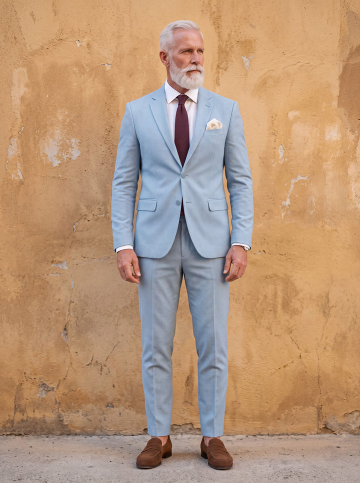 Harlan Men two-piece suit in light blue, worn by a model in a Mediterranean setting - Gentlemens Manor lifestyle