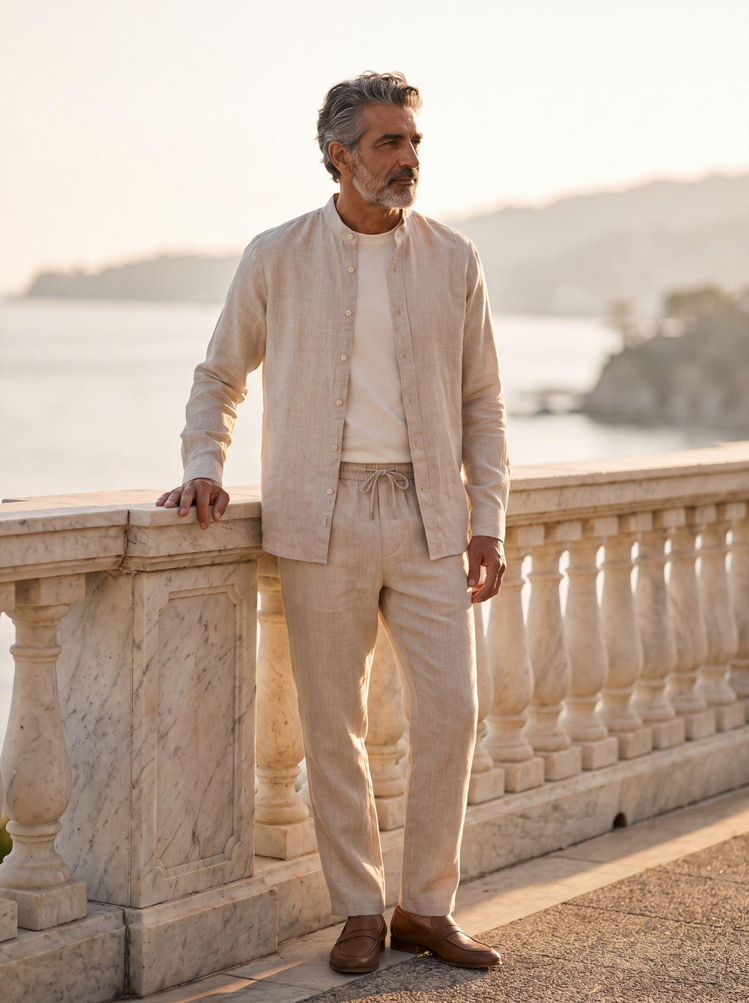 Harold Men two piece set in beige, worn by a model on a Mediterranean terrace - Gentlemens Manor lifestyle