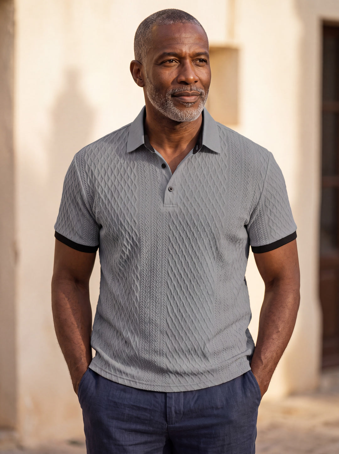 Harrison Men polo shirt in grey, worn by a model on a Mediterranean terrace - Gentlemens Manor lifestyle
