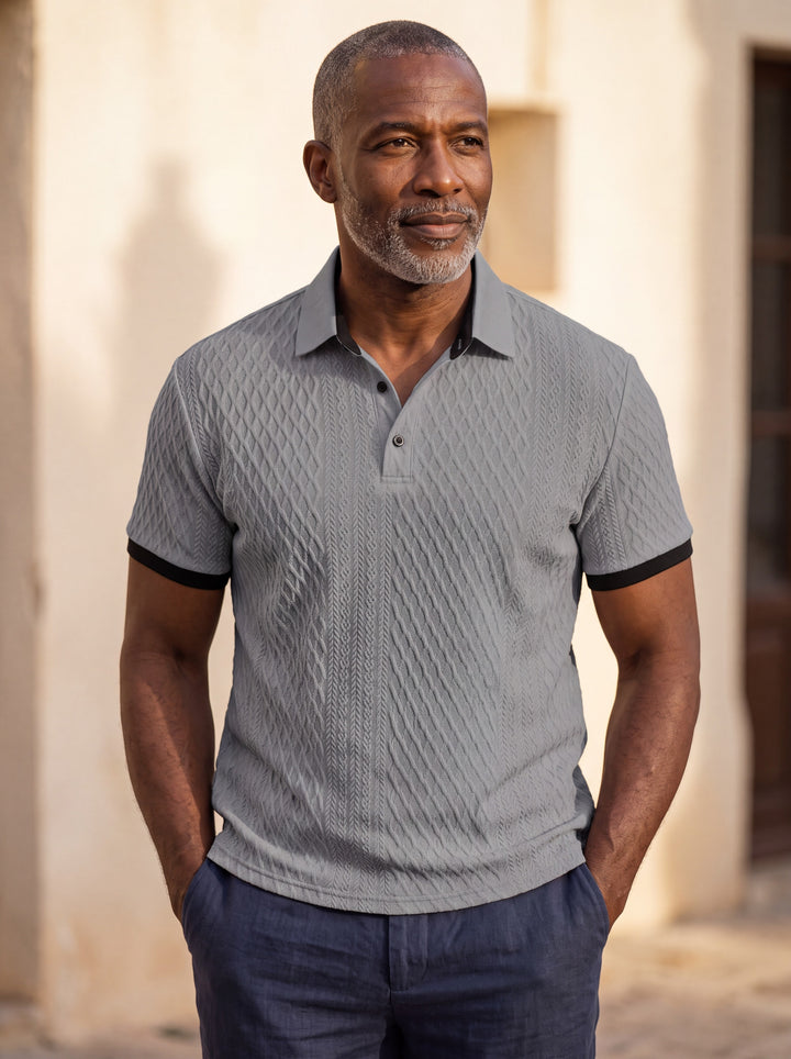 Harrison Men polo shirt in grey, worn by a model on a Mediterranean terrace - Gentlemens Manor lifestyle