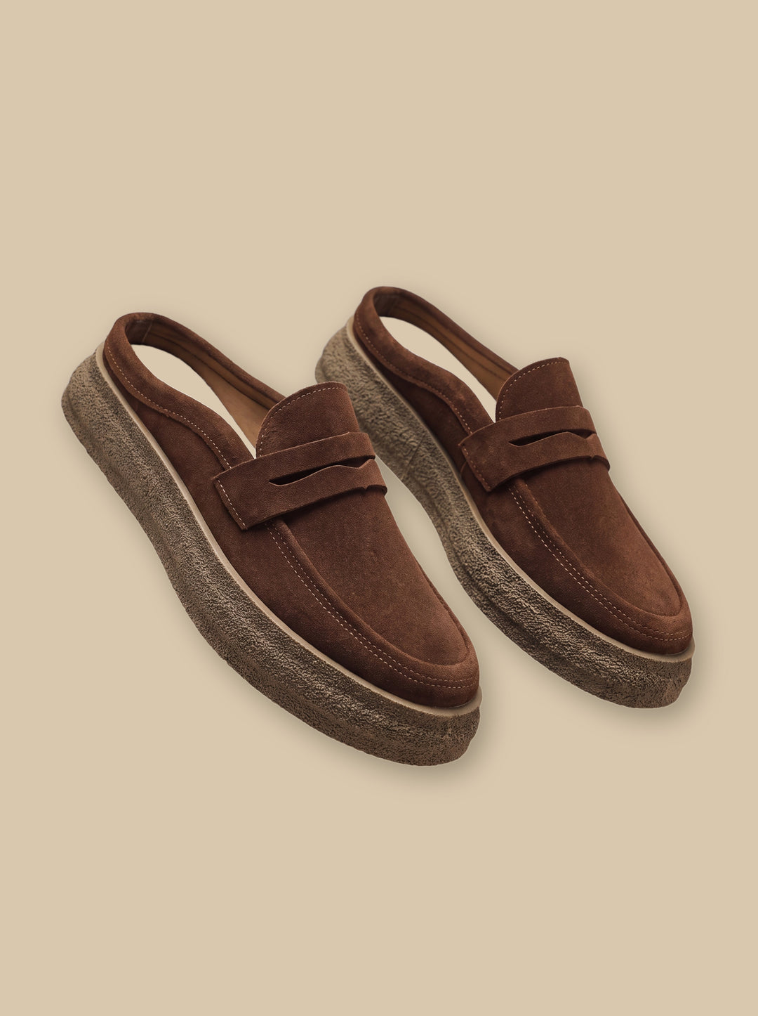Hubert loafers in Brown, on a warm sand studio background - Gentlemens Manor