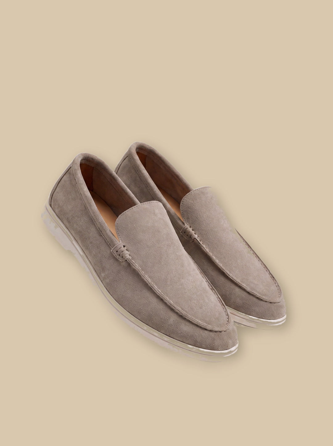 Humphrey loafers in Beige, on a warm sand studio background - Gentlemens Manor