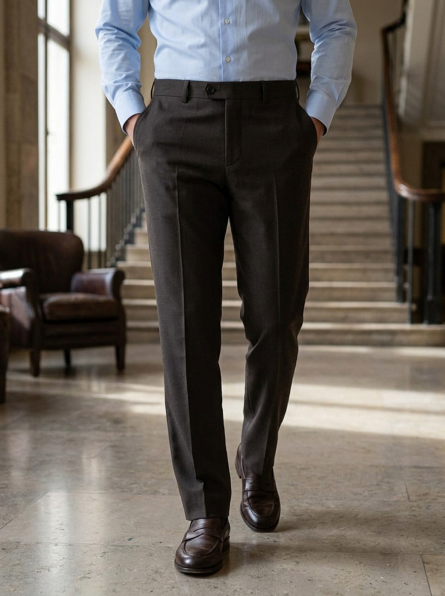 Jennings flat front button tab dress pants in Dark Brown, lifestyle in a hotel lobby, Gentlemens Manor