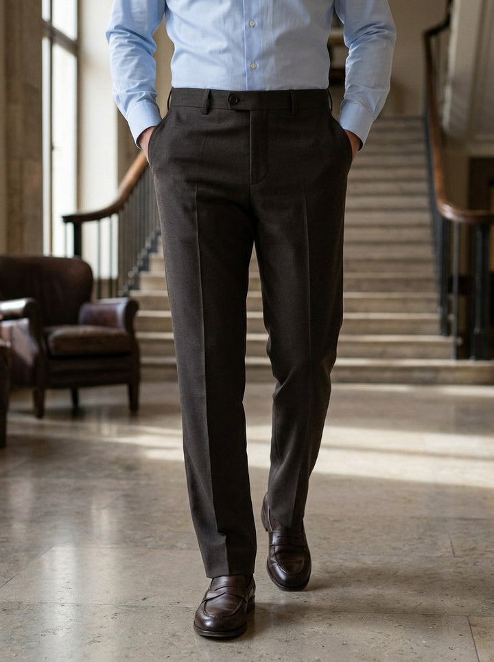 Jennings flat front button tab dress pants in Dark Brown, lifestyle in a hotel lobby, Gentlemens Manor