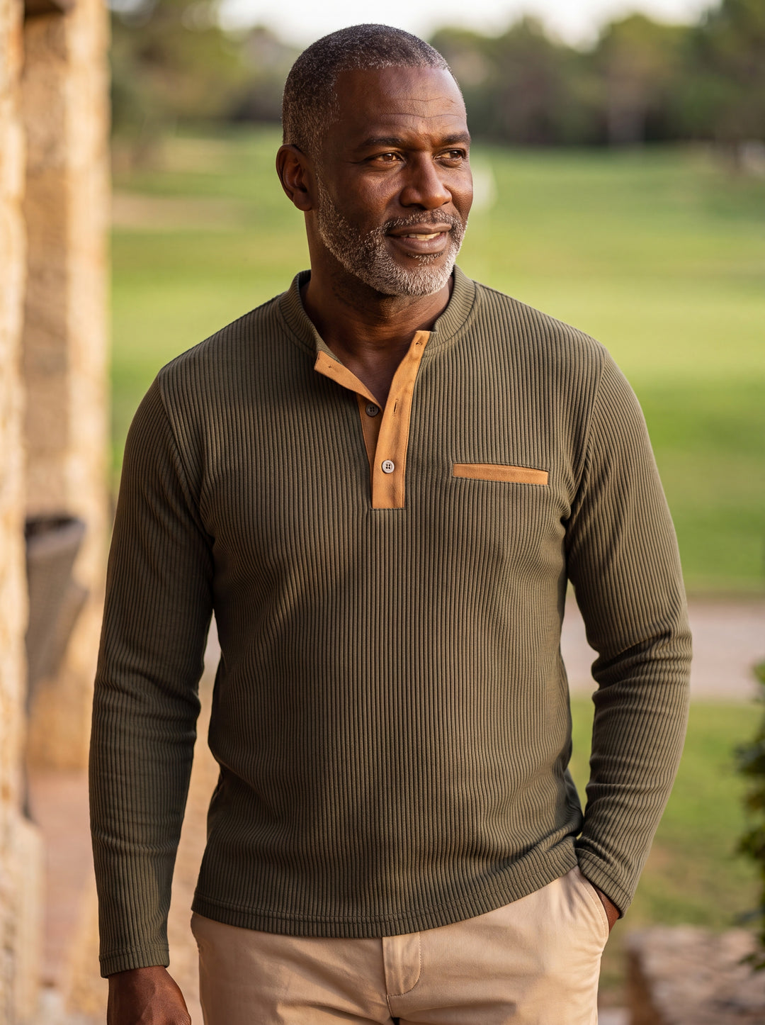 Kendall Men henley shirt in olive, worn by a model on a Mediterranean terrace - Gentlemens Manor lifestyle