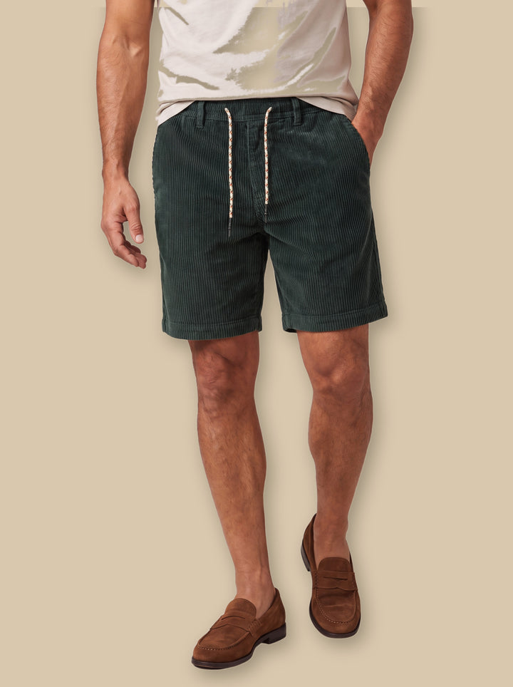 Kendall summer shorts in Green, worn by a model on a warm sand studio background - Gentlemens Manor