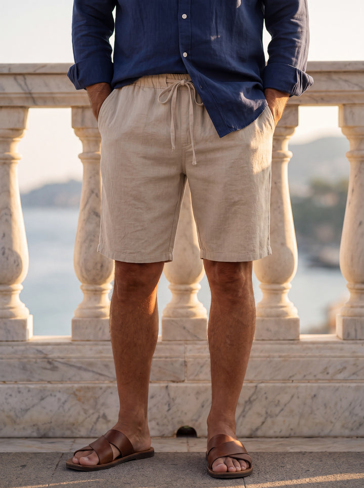 Kingsley Men beach shorts in Sand, worn by a model on a Mediterranean terrace - Gentlemens Manor lifestyle