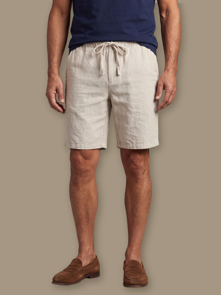 Kingsley beach shorts in Sand, worn by a model on a warm taupe studio background - Gentlemens Manor