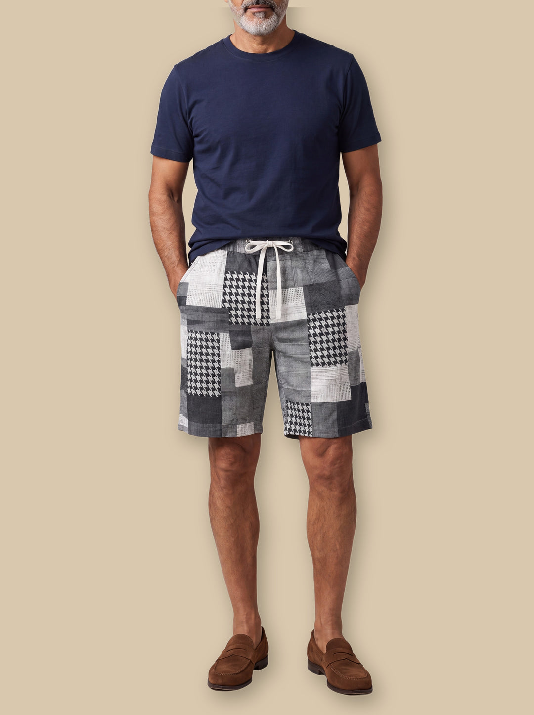 Kirby summer shorts in Grey, worn by a model on a warm sand studio background - Gentlemens Manor