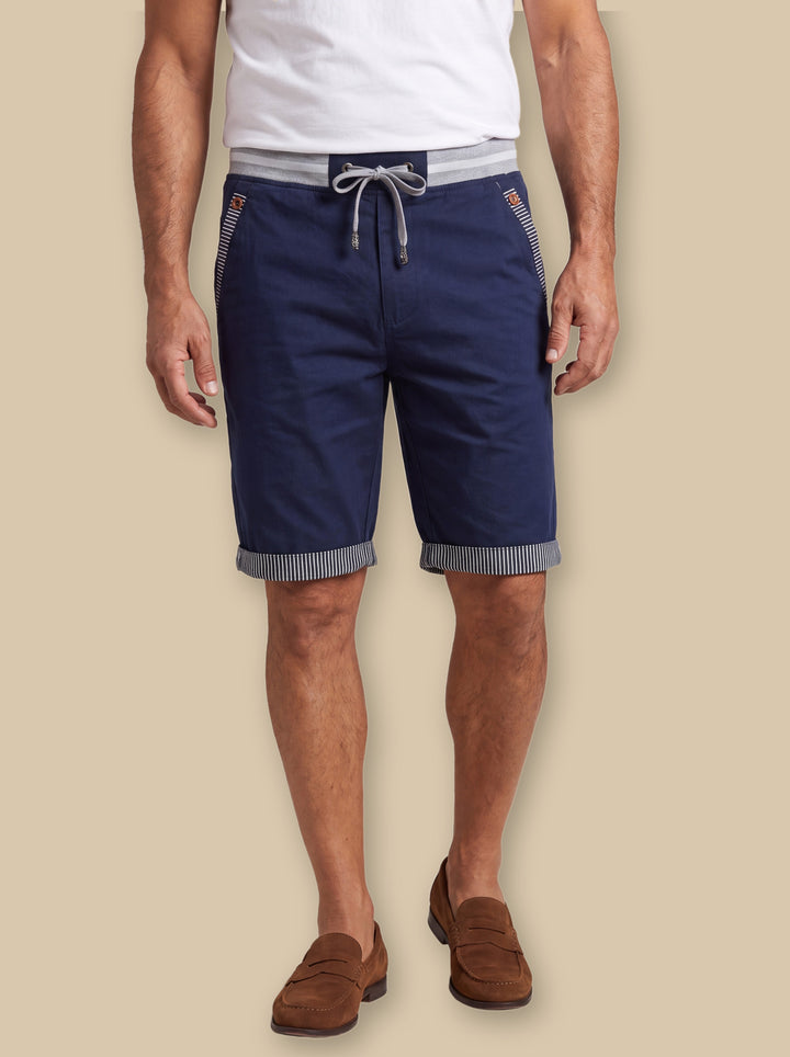 Knox summer shorts in Navy, worn by a model on a warm sand studio background - Gentlemens Manor