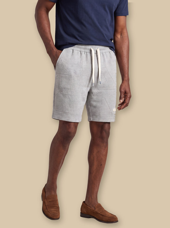 Kurt summer shorts in Grey, worn by a model on a warm sand studio background - Gentlemens Manor