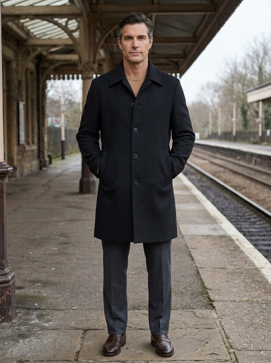 Lancaster point collar longline overcoat in Black, lifestyle on a railway platform, Gentlemens Manor
