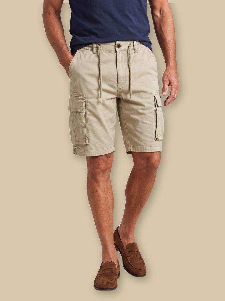 Lawson summer shorts in Sand, worn by a model on a warm sand studio background - Gentlemens Manor