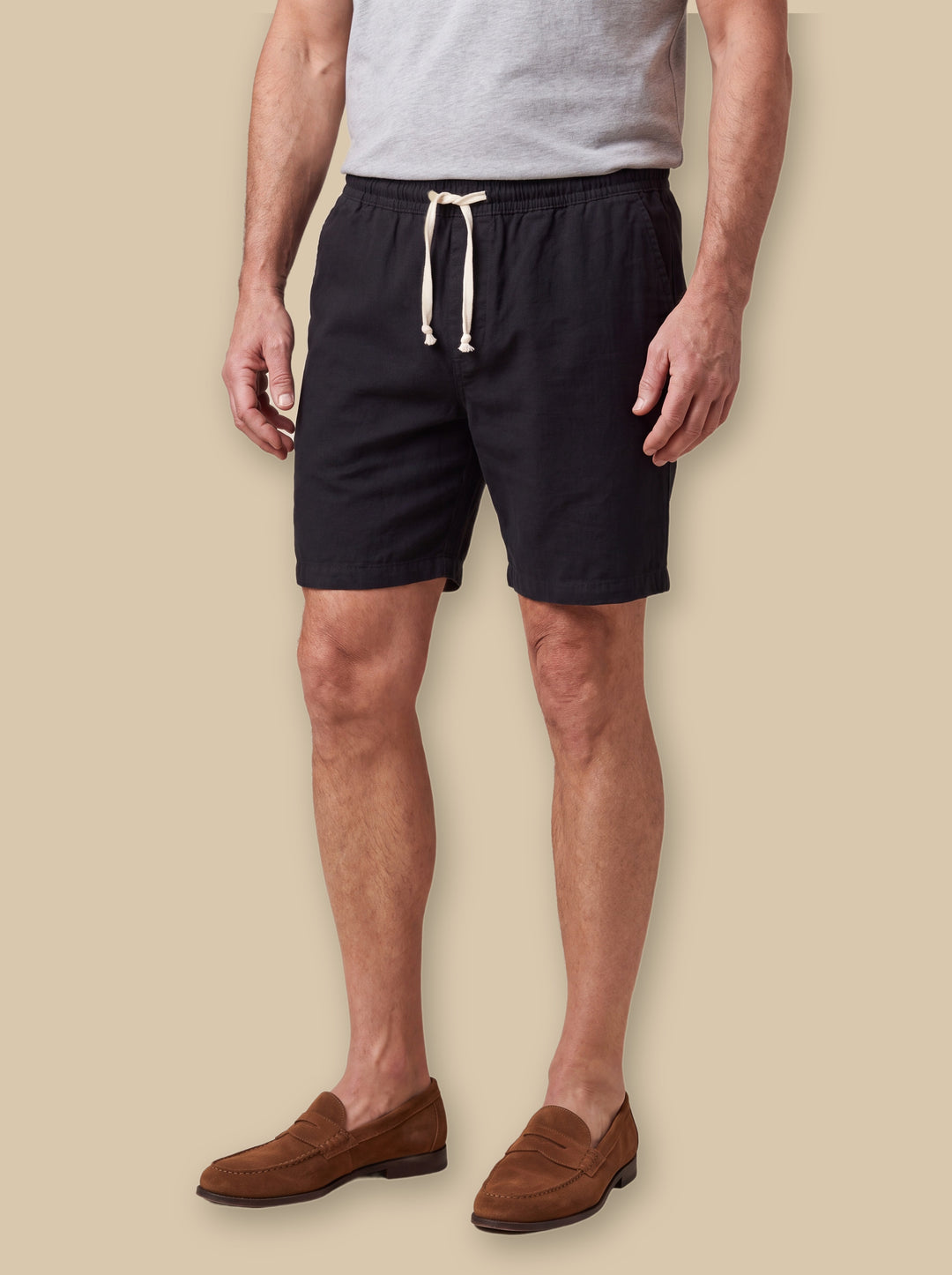 Layton beach shorts in Black, worn by a model on a warm sand studio background - Gentlemens Manor