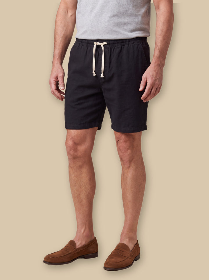 Layton beach shorts in Black, worn by a model on a warm sand studio background - Gentlemens Manor