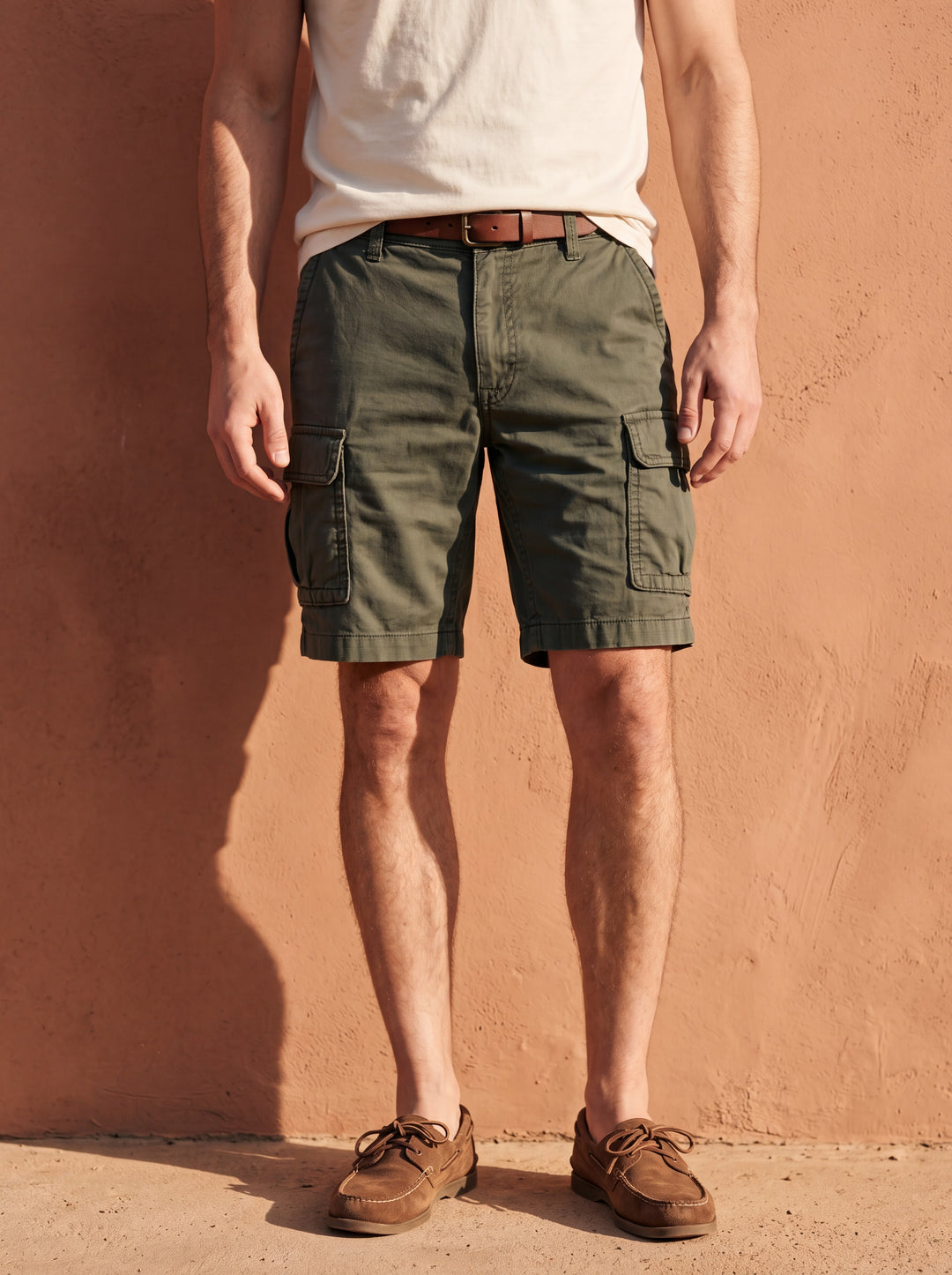 Leander Men summer shorts in green, worn by a model in a Mediterranean setting - Gentlemens Manor lifestyle
